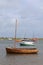 Sailing boats on the waters edge Brancaster east coast England at low tide