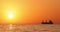 Sailing cargo ship on the sea and golden sunrise, 4k video