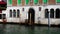 Sailing on Grand Canal past building with arch windows