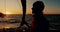 Sailing, man and sunset on a boat and yacht outdoor with water travel on a calm ocean and sea. Wind, vacation sun and