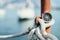 Sailing: nautical compass on a sailing rope, pier. Sailing boats in the background