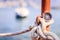 Sailing: nautical compass on a sailing rope, pier. Sailing boats in the background