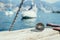 Sailing: nautical compass on wooden dock pier. Sailing boats in the background