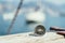 Sailing: nautical compass on wooden dock pier. Sailing boats in the background