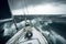 Sailing a sailboat or yacht on ocean during extreme storm with big waves, POV. Generative AI