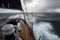 Sailing a sailboat or yacht on ocean during extreme storm with big waves, POV. Generative AI