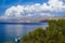 Sailing ship in the Mediterranean Sea of Greece and mountainous coastal landscape