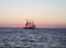 Sailing ship sunset silhouette