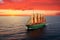 Sailing ship under sail at sunset on the high seas