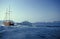 Sailing ship, white motor yacht sailing in caldera on volcanic island of Santorini