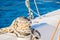 Sailing sport, nautical rope tied on winch of sailboat deck