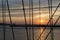 Sailing vessel ropes against sunset