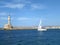 Sailing White Yacht near the Lighthouse on the Blue Aegean Sea, Crete Island, Greece