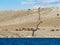 Sailing on a yacht along an island village in Croatia, farming a