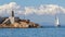 The sailing yacht leaves the port of Torrevieja in sunshine and blue sea.