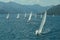 Sailing yacht race. Ships yachts with white sails in the open sea.