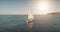 Sailing yacht race at sun light aerial. Yachting on serene seascape at open sea. Boat big white sail