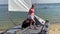 Sailing yacht, regatta. Happy young woman is going to sail on catamaran, summer vacation on a sailing boat. Collecting