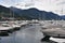 Sailing yachts arranged in rows in a marina covered for winter season and with lowered sails.