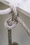 Sailor knot made with thick white rope with white rusty background