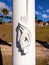 Sailor knot on white wooden post and French West Indies background. Close-up of white navigation rope. Cordage and nautical