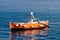 Sailor rowing on wooden taxi boat