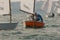 Sailor in a sailboat on a competition in Optimist class on open waters on the sea during sunny weather