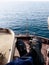 A sailor sitting top of the ships forward mast light