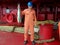 Sailor in uniform shows his lucky catch - big fish caught in ocean from ship deck of oil tanker