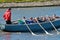 Sailors compete on rowing boats.