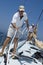 Sailors Working Ropes On Yacht Deck