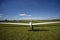 Sailplane landing on a grass, sunny day in Szczecin.