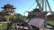 The sails of a wooden ship against the background of a Chinese house. Antique wooden boat mast