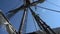 The sails of a wooden ship against the background of a Chinese house. Antique wooden boat mast