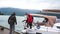 Sailsmen hang mooring buoys on railing of yacht in city port