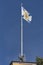 Saint Andrew Andreevsky flag Ensign of the Russian Navy on a flagpole waving the roof of the Admiralty building on a blue sky