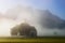 Saint Coloman church with warm light shining through the fog near Neuschwanstein Castle, Fussen, Bavaria, Germany