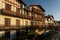 SAINT JEAN DE LUZ, FRANCE - SEPTEMBER 04, 2022: Traditional Basque houses in Jacques Thibaud walk in front of Big beach at sunset