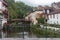 Saint Jean Pied de Port, France - 10/06/2019: medieval landmark with footbridge and houses on riverbank. Pilgrimage centre.