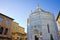 Saint John`s baptistery in Pistoia city built in the year 1303 with an octagonal base - On the left the Episcopal Palace Tuscany