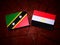 Saint Kitts and Nevis flag with Egyptian flag on a tree stump is