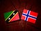 Saint Kitts and Nevis flag with Norwegian flag on a tree stump i