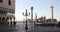 Saint Mark square and column with lion statue, people at sunrise in Venice, Italy