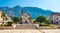 Saint Marko cathedral and church at Makarska city, Croatia. The Biokovo mountains in the background. Sunny day at summer, green