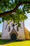 Saint Martin`s Church in Valjala, Saaremaa, Estonia. Example of Romanesque baptismal. Old stone church with trees around