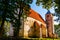 Saint Martin`s Church in Valjala, Saaremaa, Estonia. Example of Romanesque baptismal. Old stone church with trees around