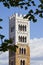 Saint Michael`s bell tower detail built with stone and white marble Italy - Tuscany - Lucca city - Image with copy space