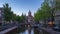 Saint Nicholas Church with Canal and Dutch buildings in Amsterdam city, Netherlands day to night time lapse