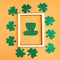 Saint Patrick leprechaun paper hat isolated on bright orange background.