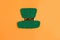 Saint Patrick leprechaun paper hat isolated on bright orange background.